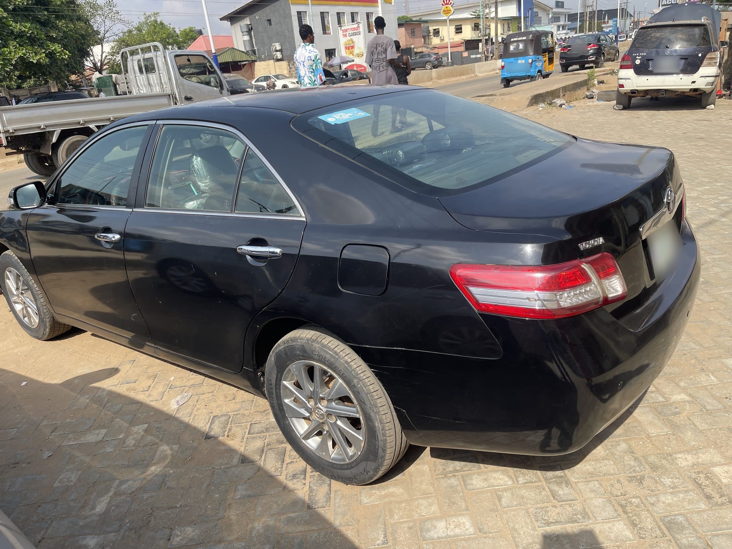 Black Toyota Camry saloon seen from the rear