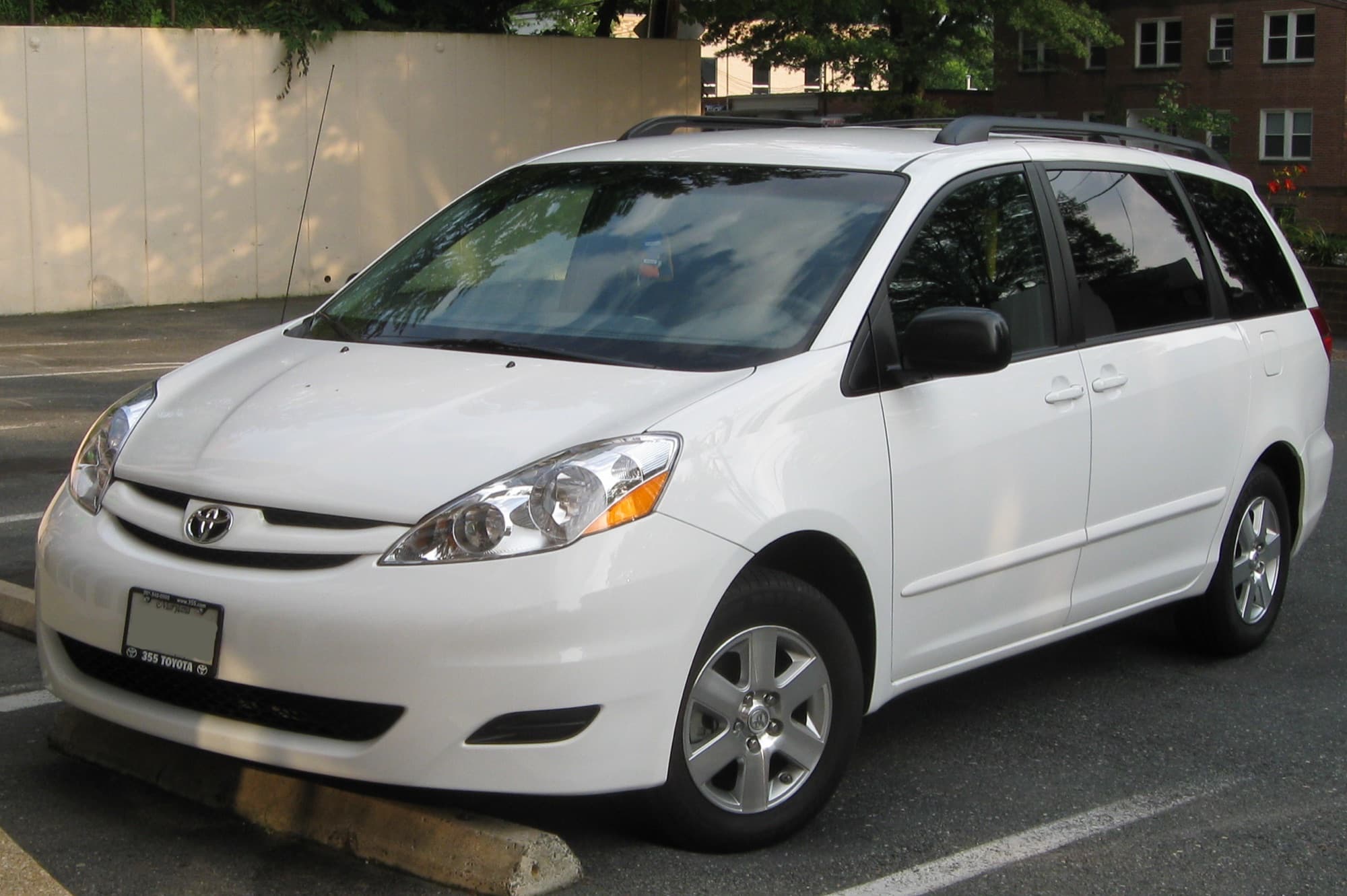 White Toyota Sienna minivan parked in a car park